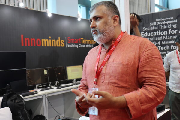 Middle aged indian software engineer looking at another person in conversation