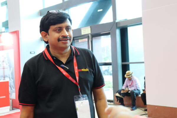 Middle aged handsome indian hardware and software computer engineer smiling and talking another person